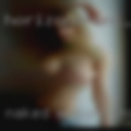 Naked woman inserting tampon